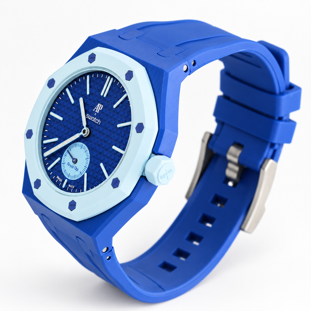 Royal Pop LAN BA angled view showing blue rubber strap, light-blue bezel and silver-tone buckle on white background