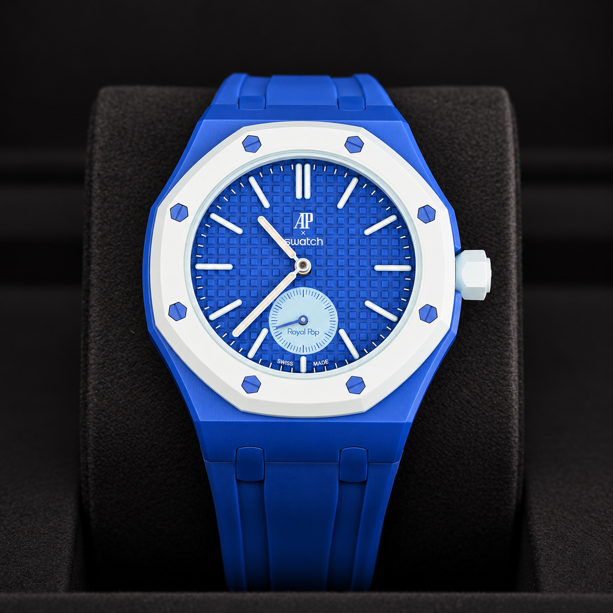 Royal Pop LAN BA front close-up showing blue dial, small seconds subdial and blue rubber strap on a black cushion