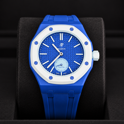Royal Pop LAN BA front close-up showing blue dial, small seconds subdial and blue rubber strap on a black cushion