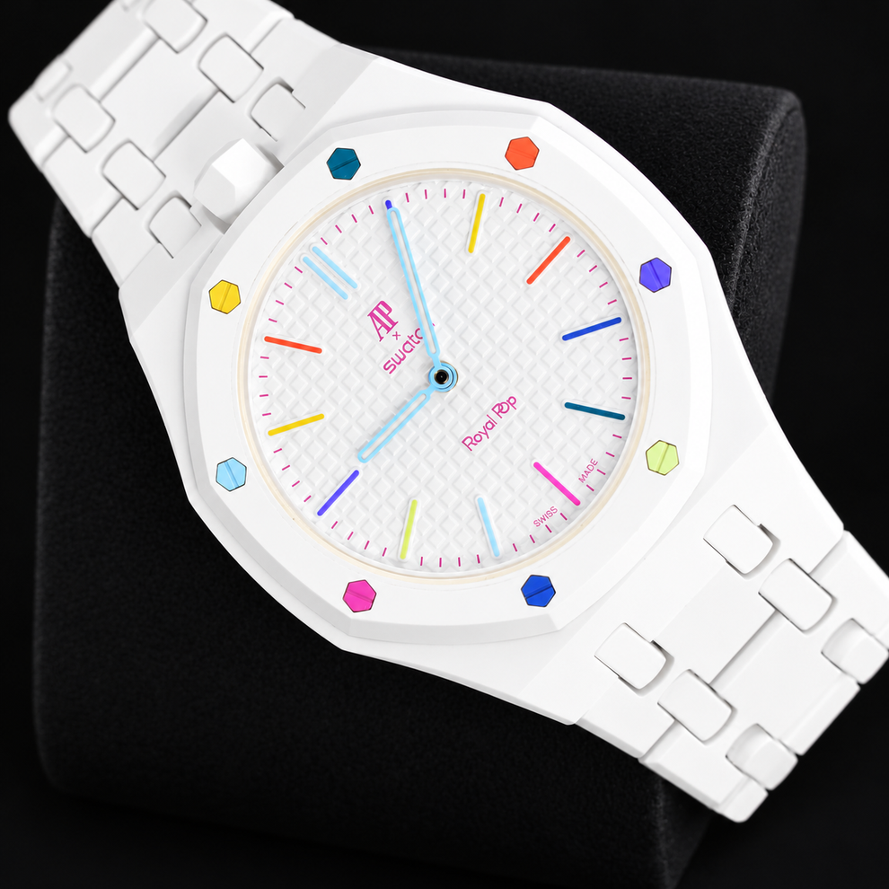 Royal Pop HUIT BLANC diagonal front view with white linked bracelet and multicoloured dial accents on a black cushion