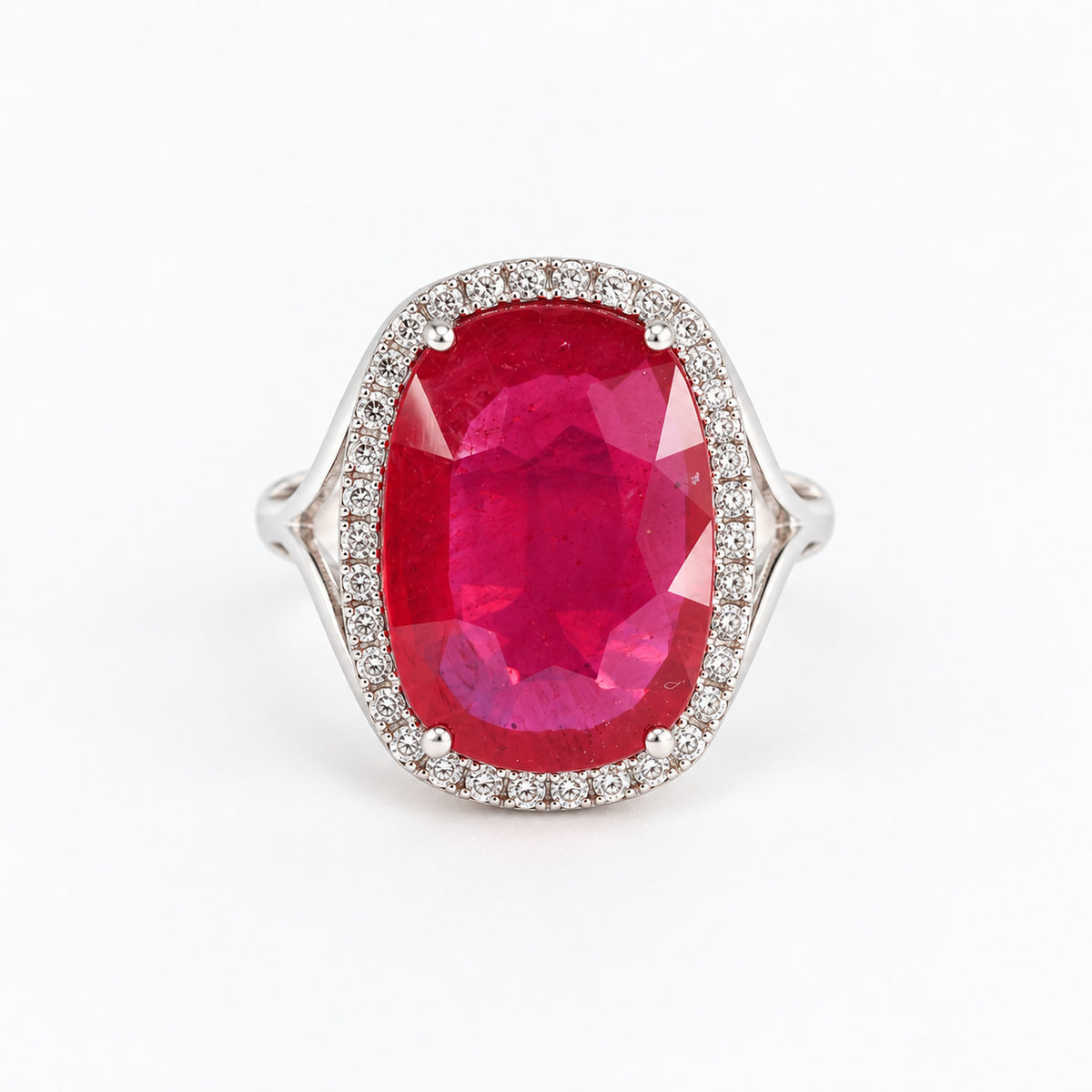 Front view of 18ct white gold glass-filled ruby ring with natural diamond halo