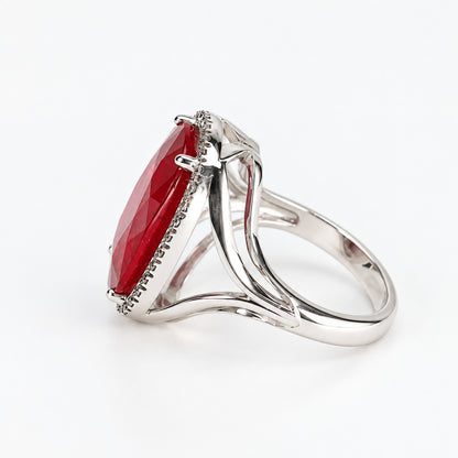 Right-side profile of 18ct white gold oval glass-filled ruby and natural diamond halo ring showing the raised setting