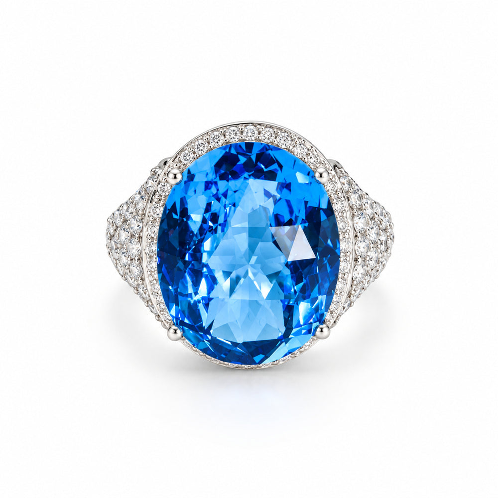 Oval blue topaz and natural diamond halo ring in 18ct white gold, front view.