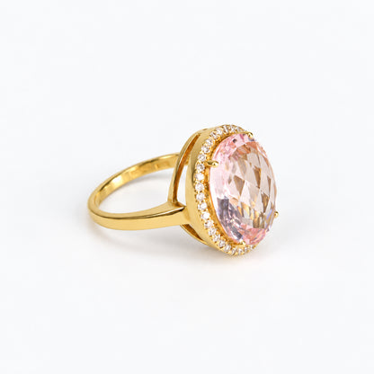 Three-quarter angle of 18ct yellow gold morganite halo ring with natural diamonds