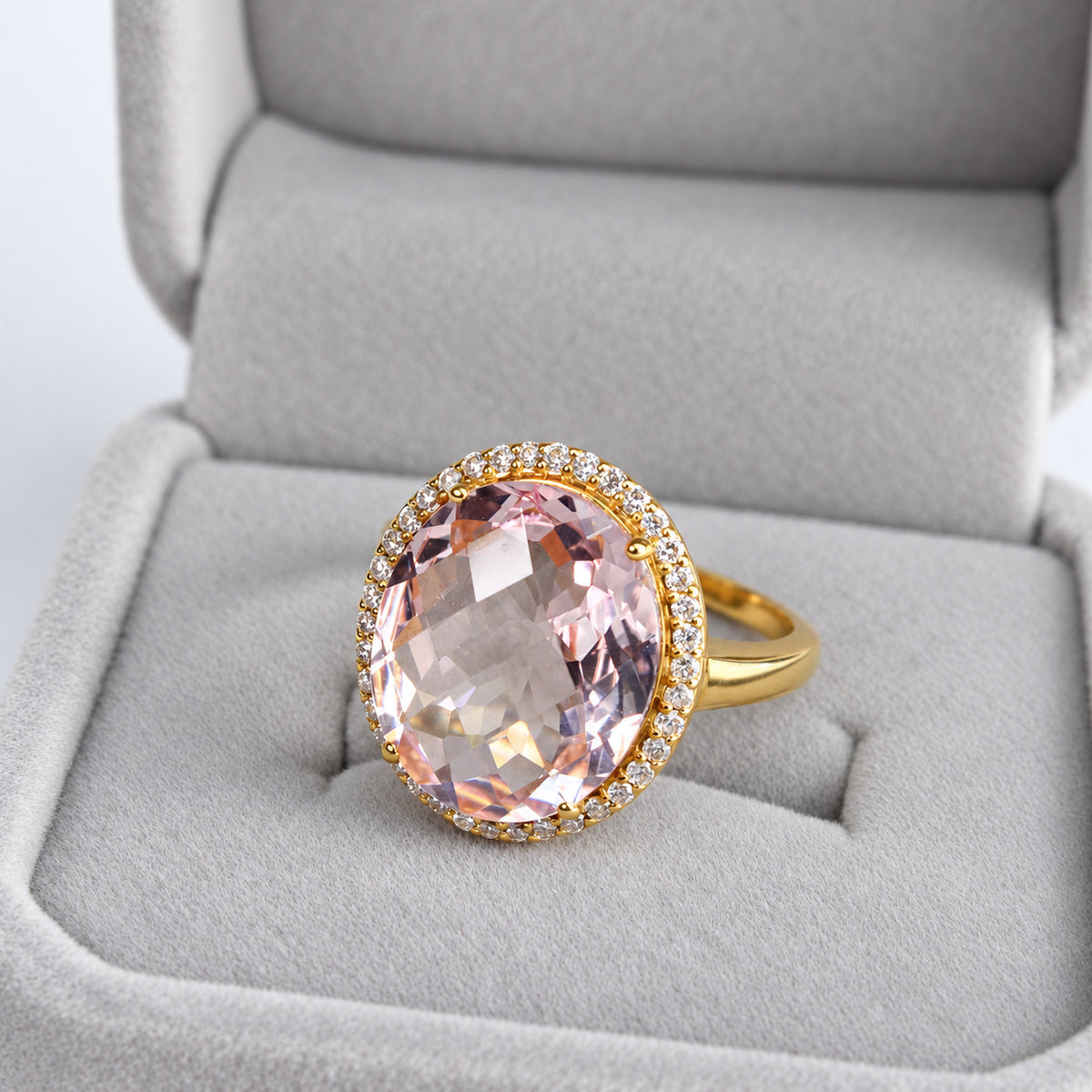 Overhead view showing large oval pink morganite framed by natural diamonds in yellow gold