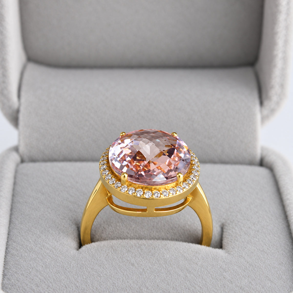 Front angle of oval pink morganite natural diamond halo ring in grey presentation box