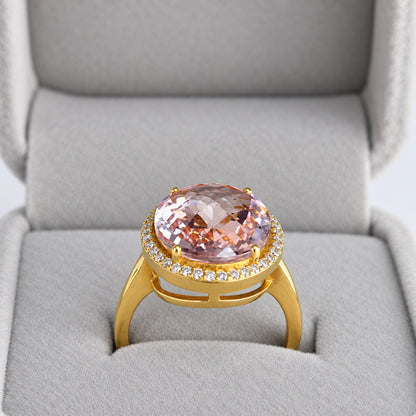 Front angle of oval pink morganite natural diamond halo ring in grey presentation box