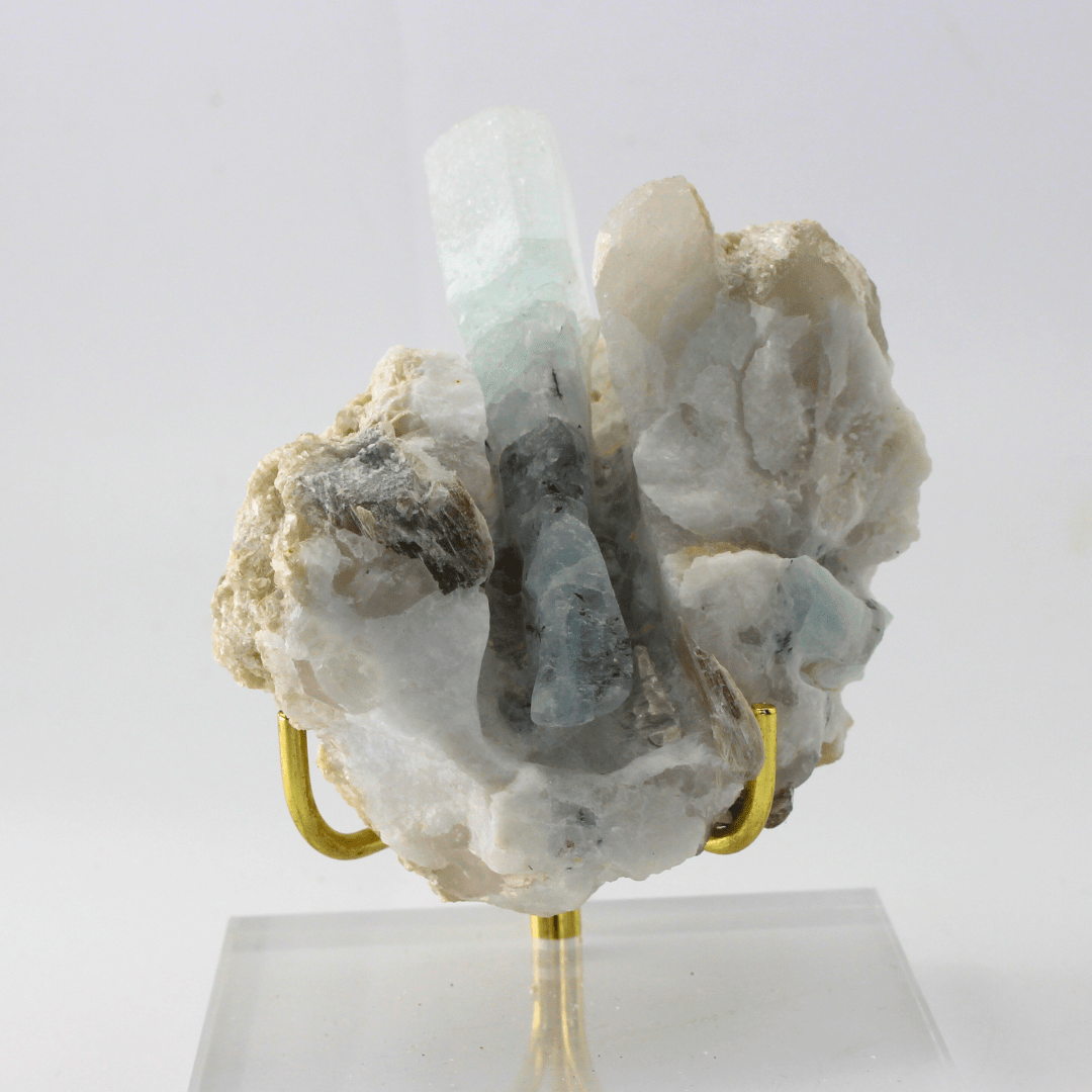 Mineral specimen on a stand with a white background