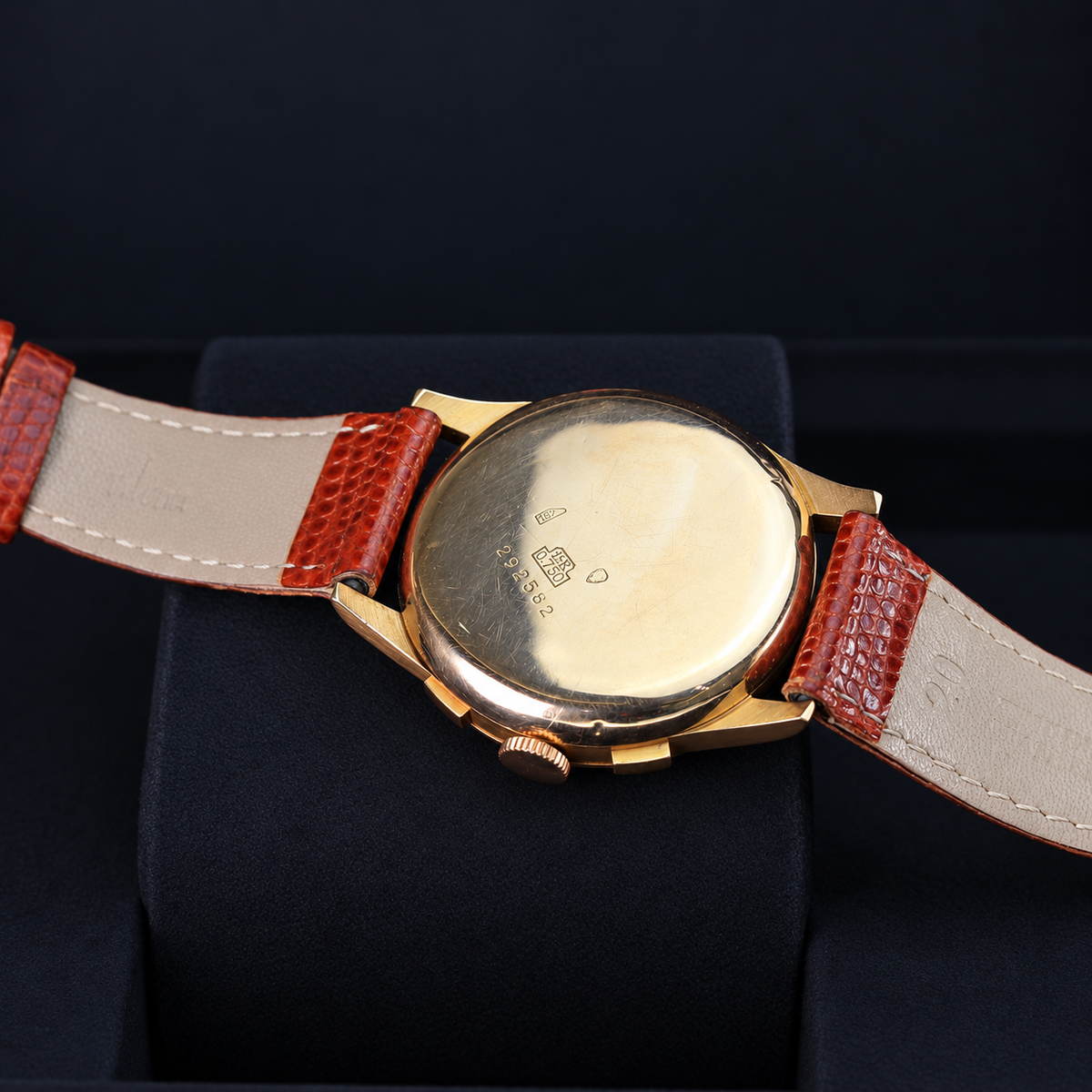 Exactus Chronographe vintage chronograph caseback showing 18K 0.750 hallmarks and brown leather strap