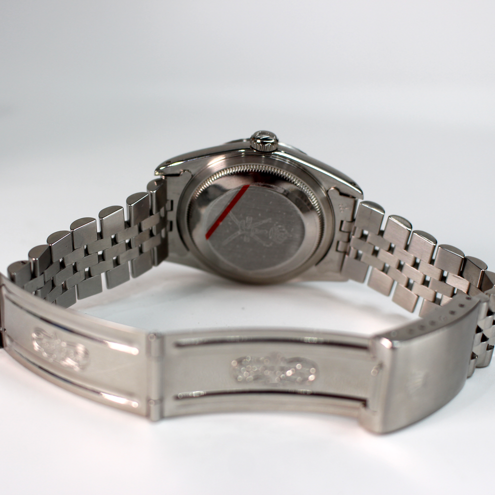Silver watch with a detailed metal band on a white background