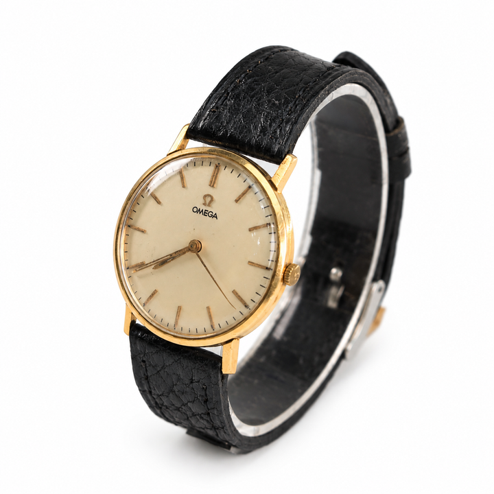 Vintage Omega dress watch with champagne dial, yellow gold-tone case and black leather strap