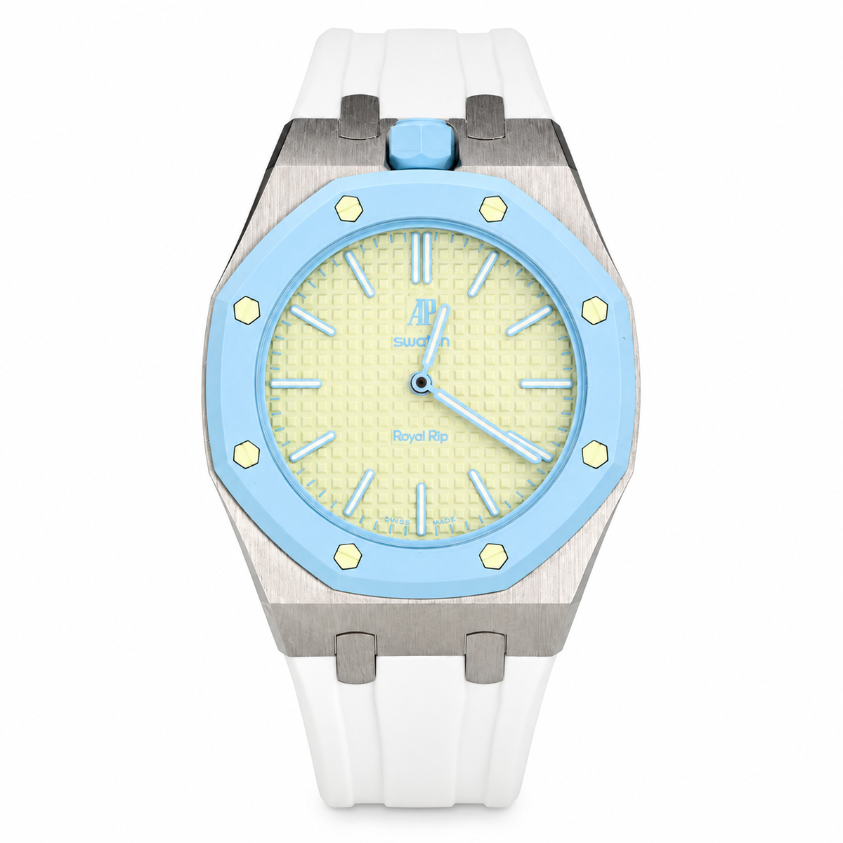 A luxury watch featuring a white silicone strap, a brushed stainless steel case, a light blue bezel, and a pale yellow dial with a blue crown.