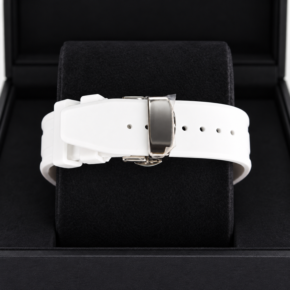 A white silicone watch strap with a silver-toned metal buckle, displayed on a black velvet watch cushion inside a black presentation box.