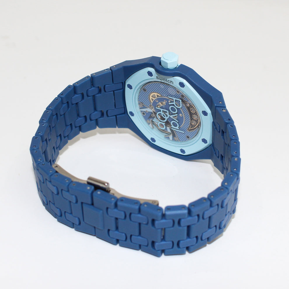 Royal Pop LAN BA transparent caseback showing the movement and Royal Pop lettering with navy-blue linked bracelet