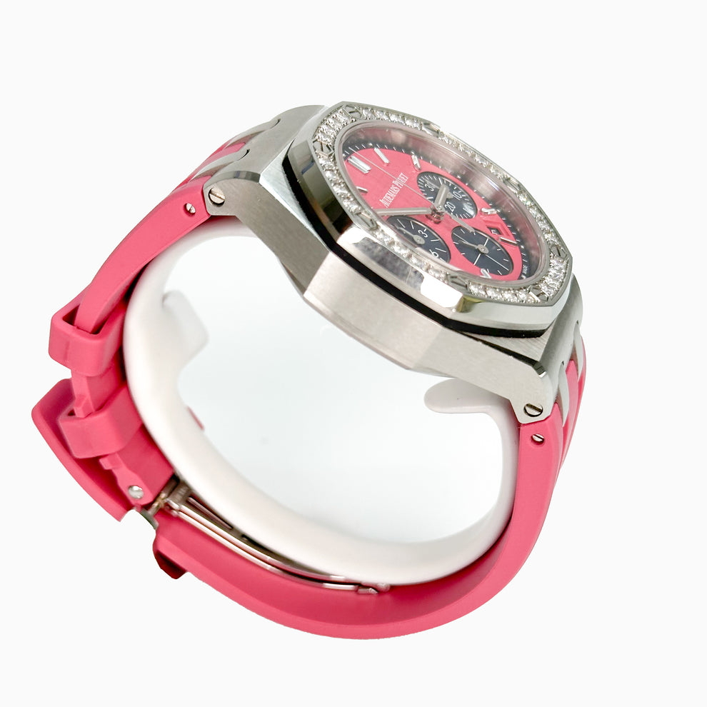 Pink watch with a silver case on a white background