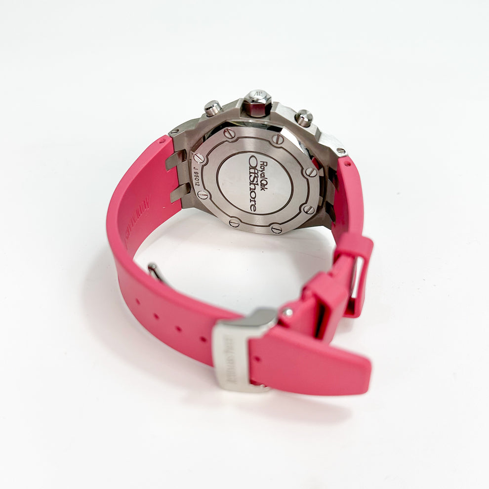 Close-up of a watch with a pink strap on a white background