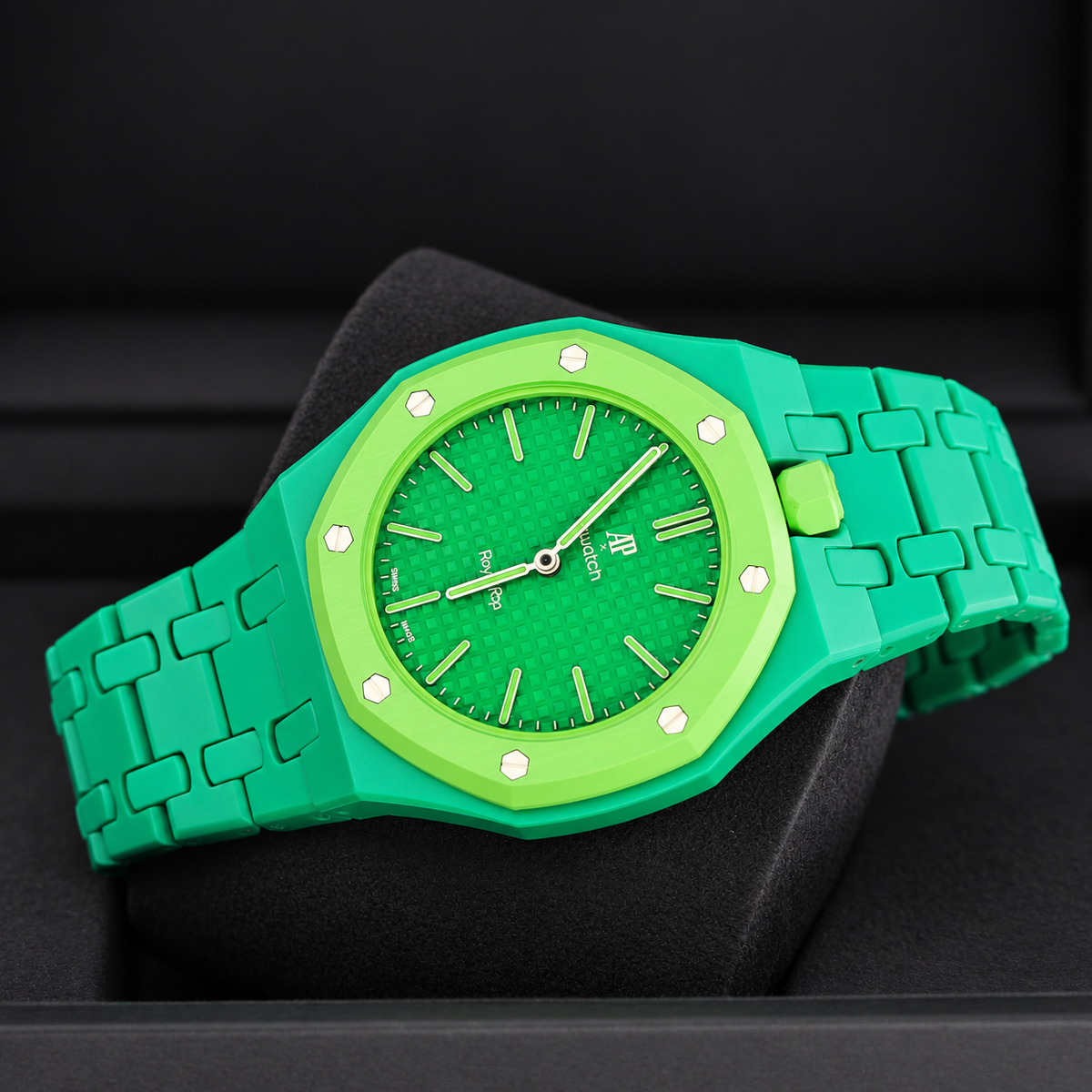 Royal Pop GREEN EIGHT with green linked bracelet and lime-green crown viewed diagonally on a black cushion