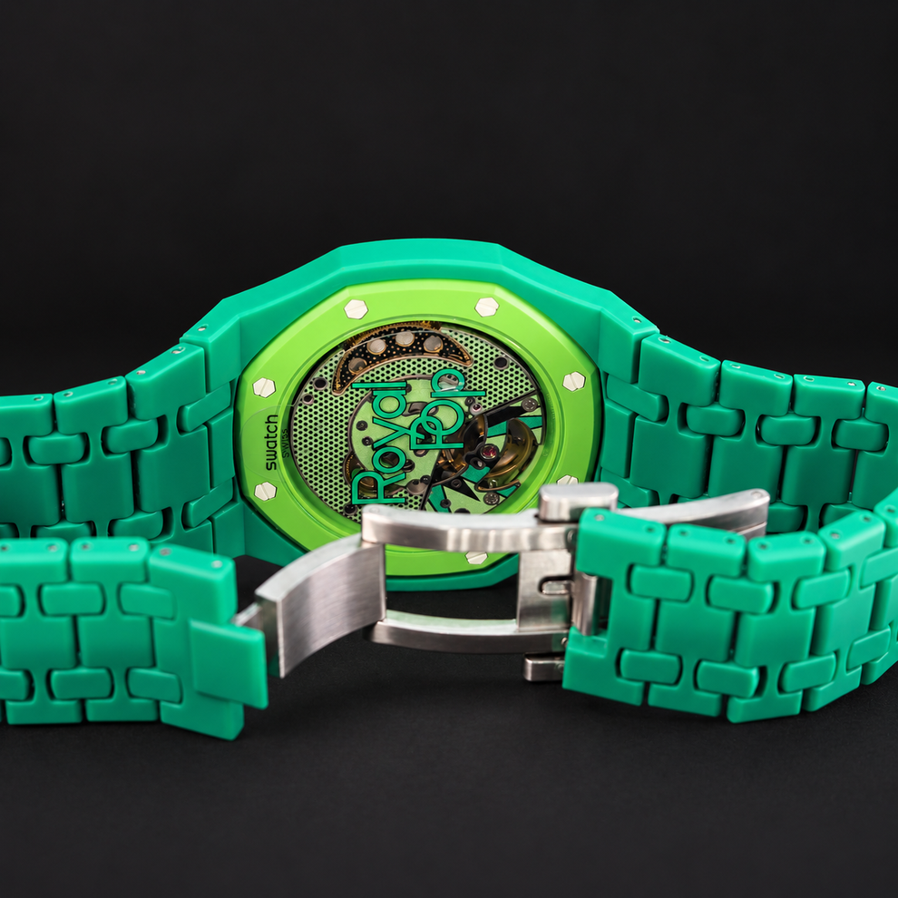 Royal Pop GREEN EIGHT transparent caseback showing the movement with green bracelet and open silver-tone clasp