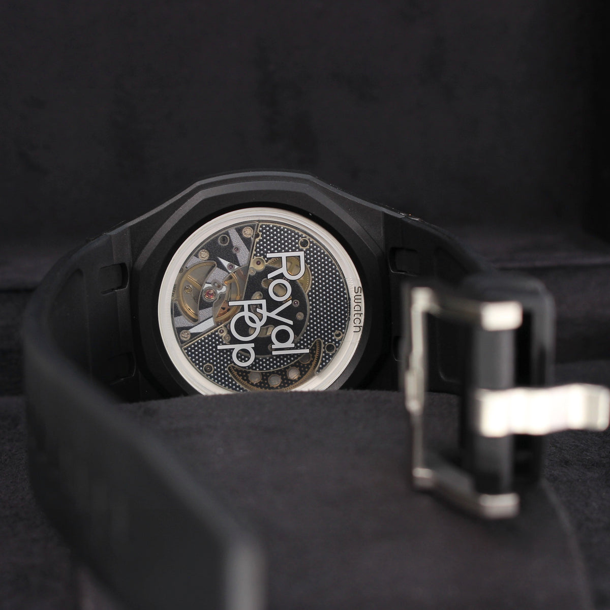 Royal Pop OCHO NEGRO rear view showing transparent caseback, black strap and open silver-tone buckle