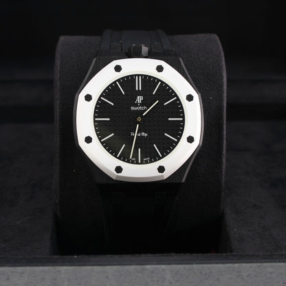 Royal Pop OCHO NEGRO with black strap and white octagonal bezel displayed upright on a black cushion