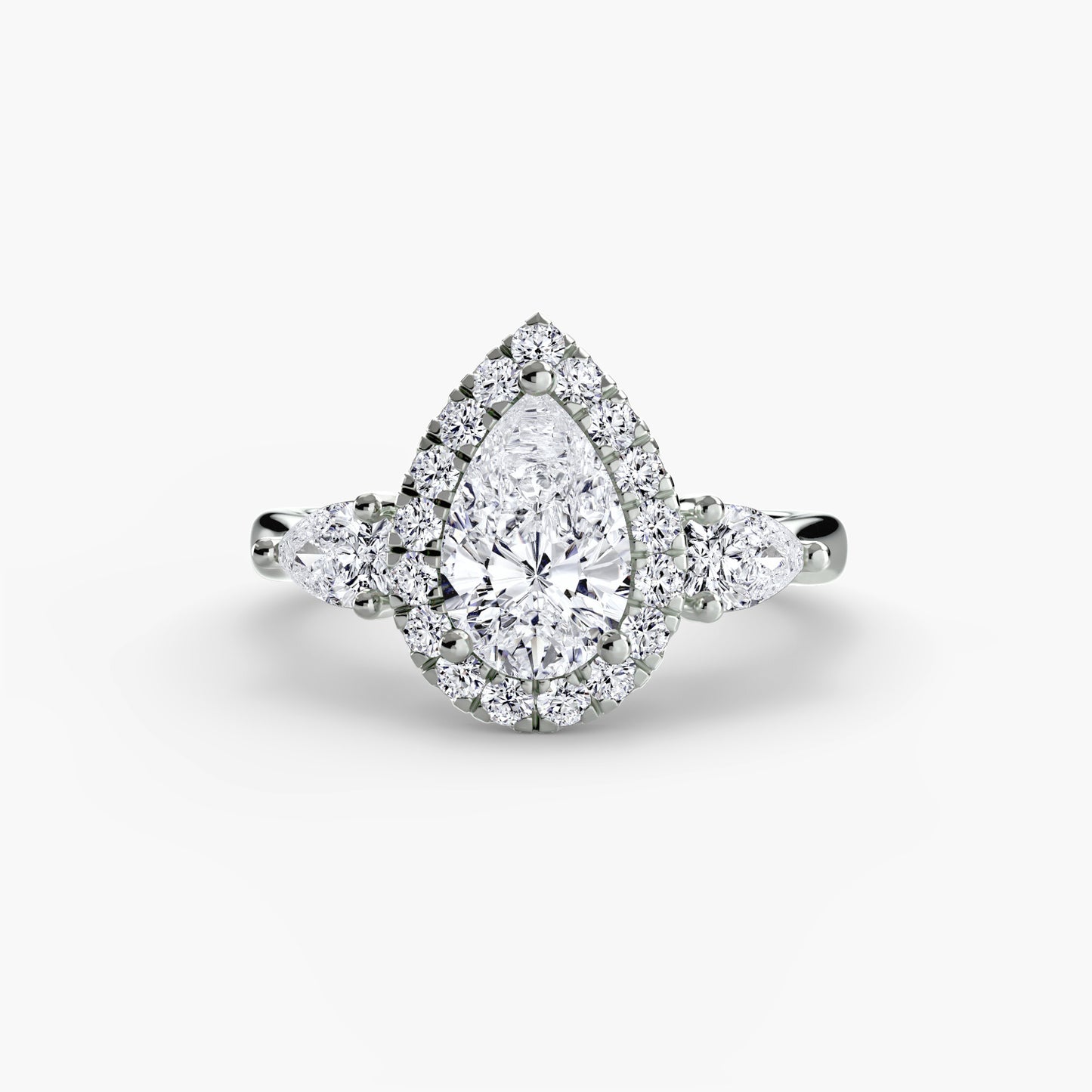 Diamond ring with a pear-shaped center stone on a white background
