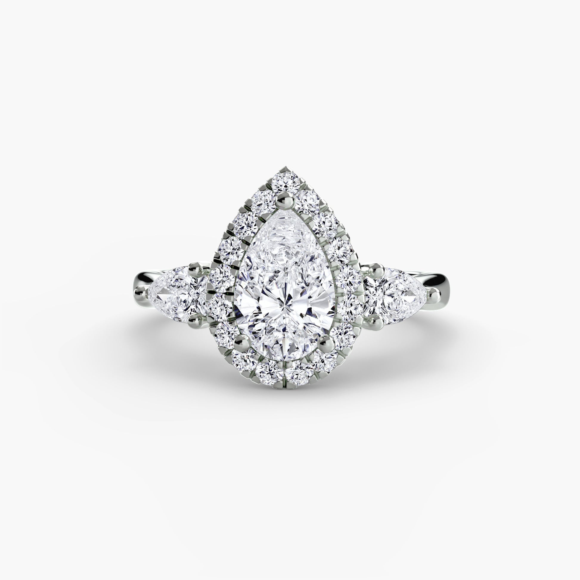 Diamond ring with a pear-shaped center stone on a white background