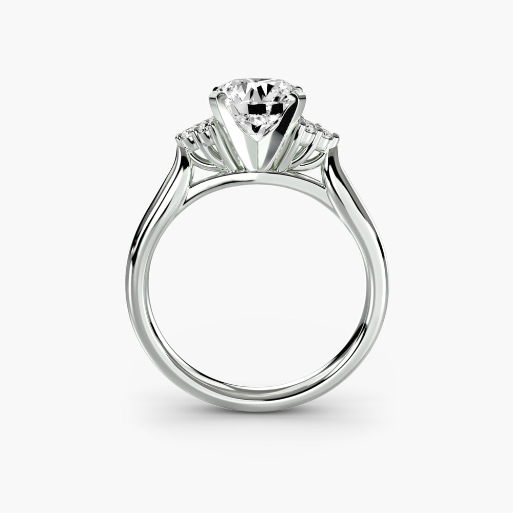 Front view of a 9K white gold cluster-shoulder solitaire engagement ring setting for a round centre stone