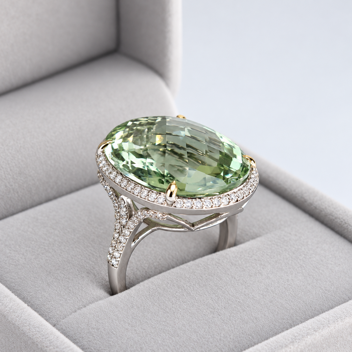 Three-quarter view of green amethyst ring showing faceted centre stone and diamond-set split shoulders
