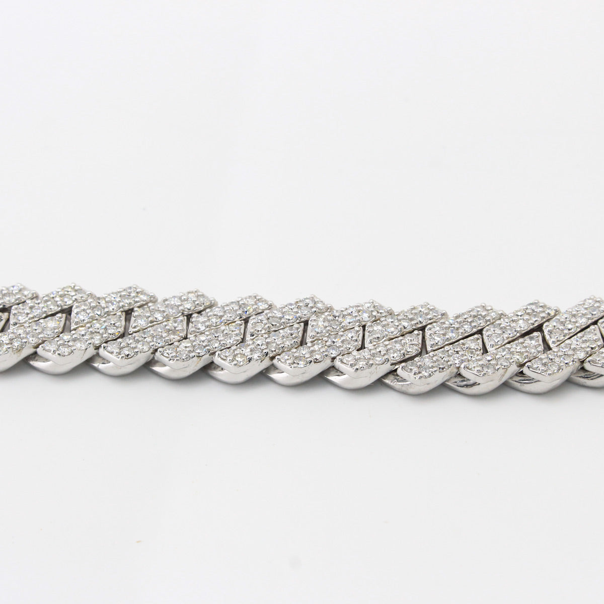 white gold chain bracelet on a light gray background