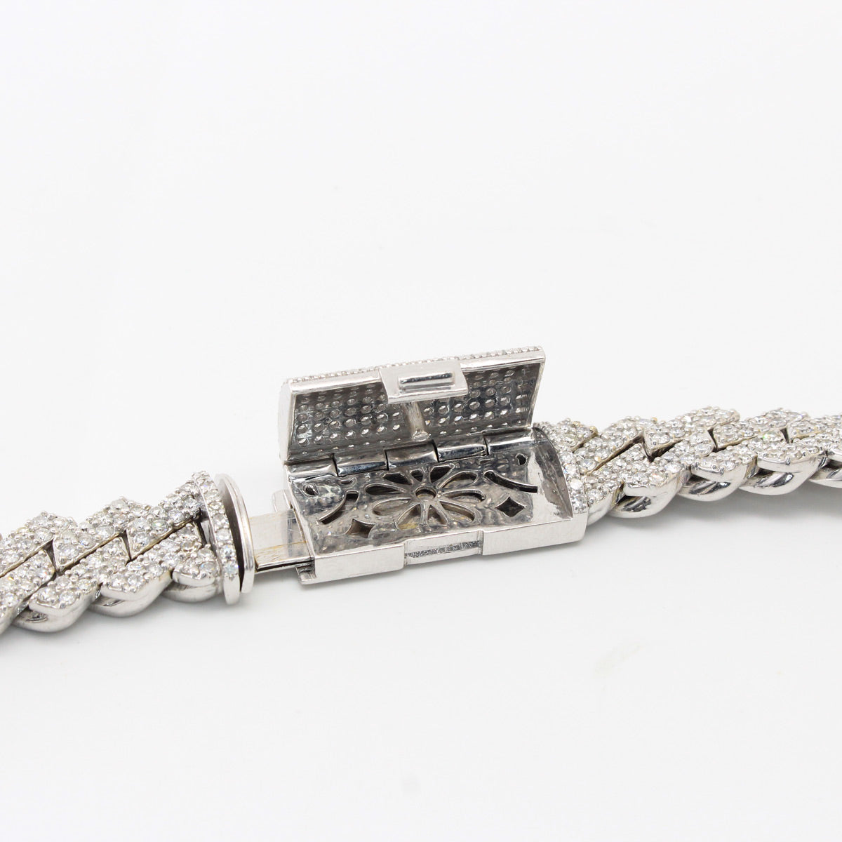 white gold bracelet with a decorative clasp on a white background