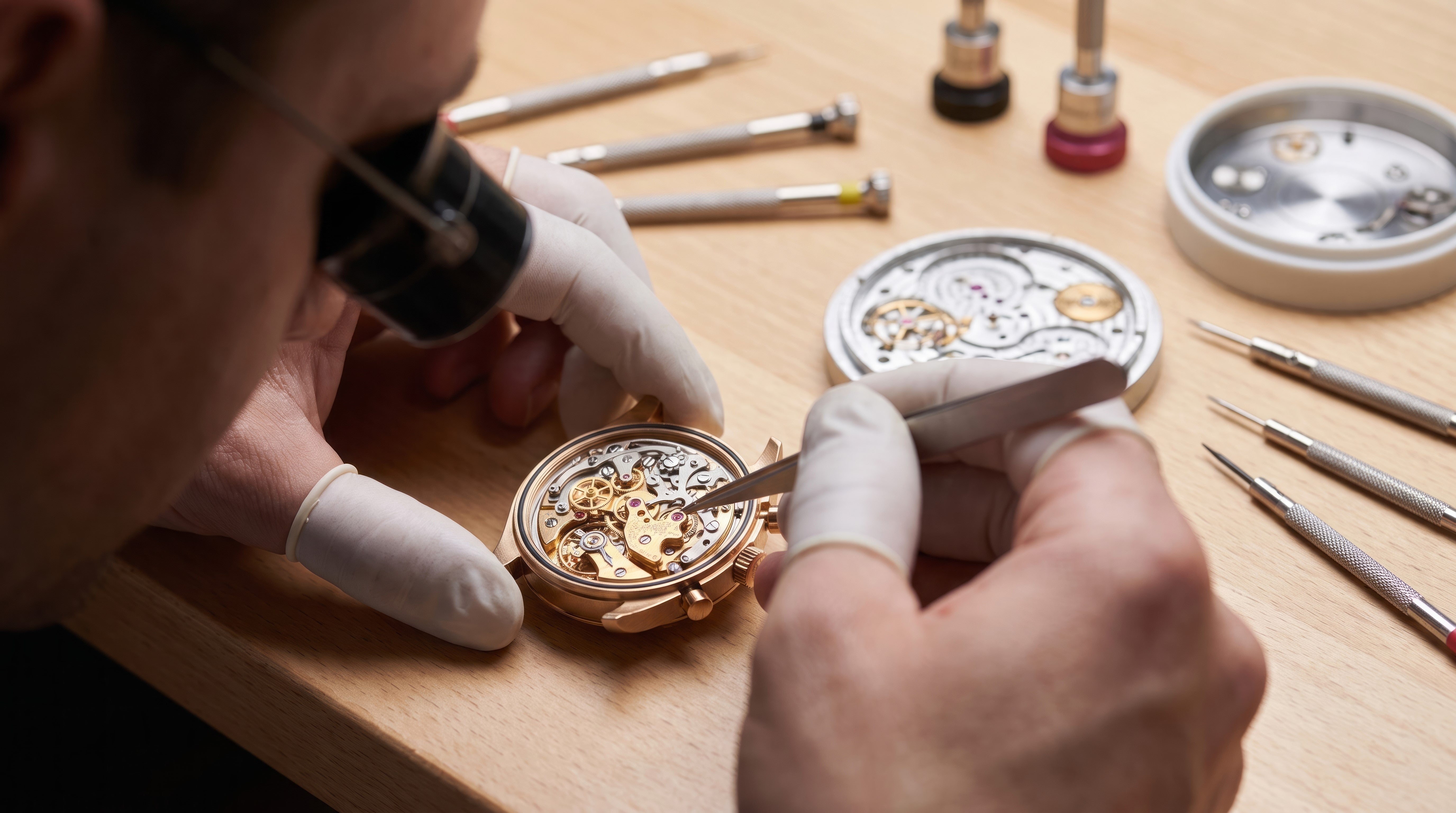 Watch specialist inspecting a mechanical watch for authentication at Imperial Time Kensington