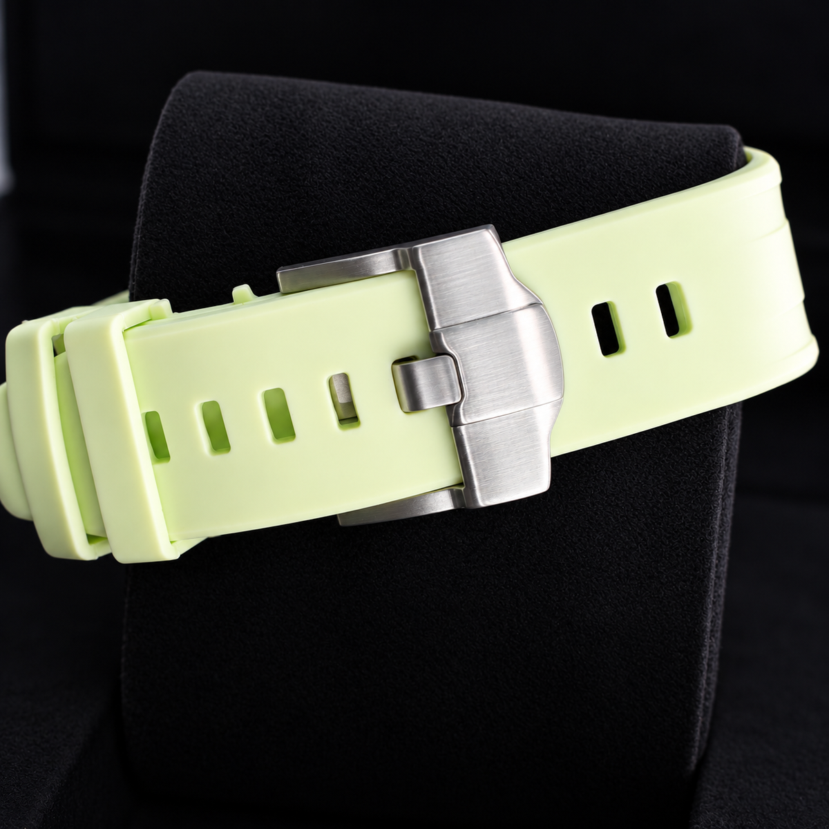 Royal Pop Blaue Acht lime watch strap with silver-tone buckle on a black cushion